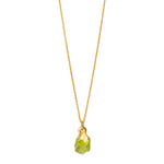 A raw crystal Peridot pendant necklace on a gold chain, with the pendant displaying a bright green color.