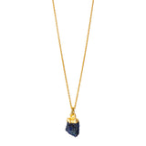 A raw Sapphire pendant electroplated in gold, hanging from a gold cable chain.